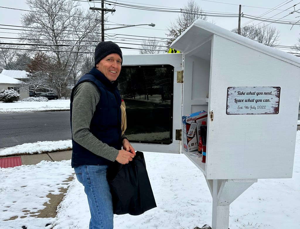 Joseph Lawver stocking the white Pennington pantry box in winter