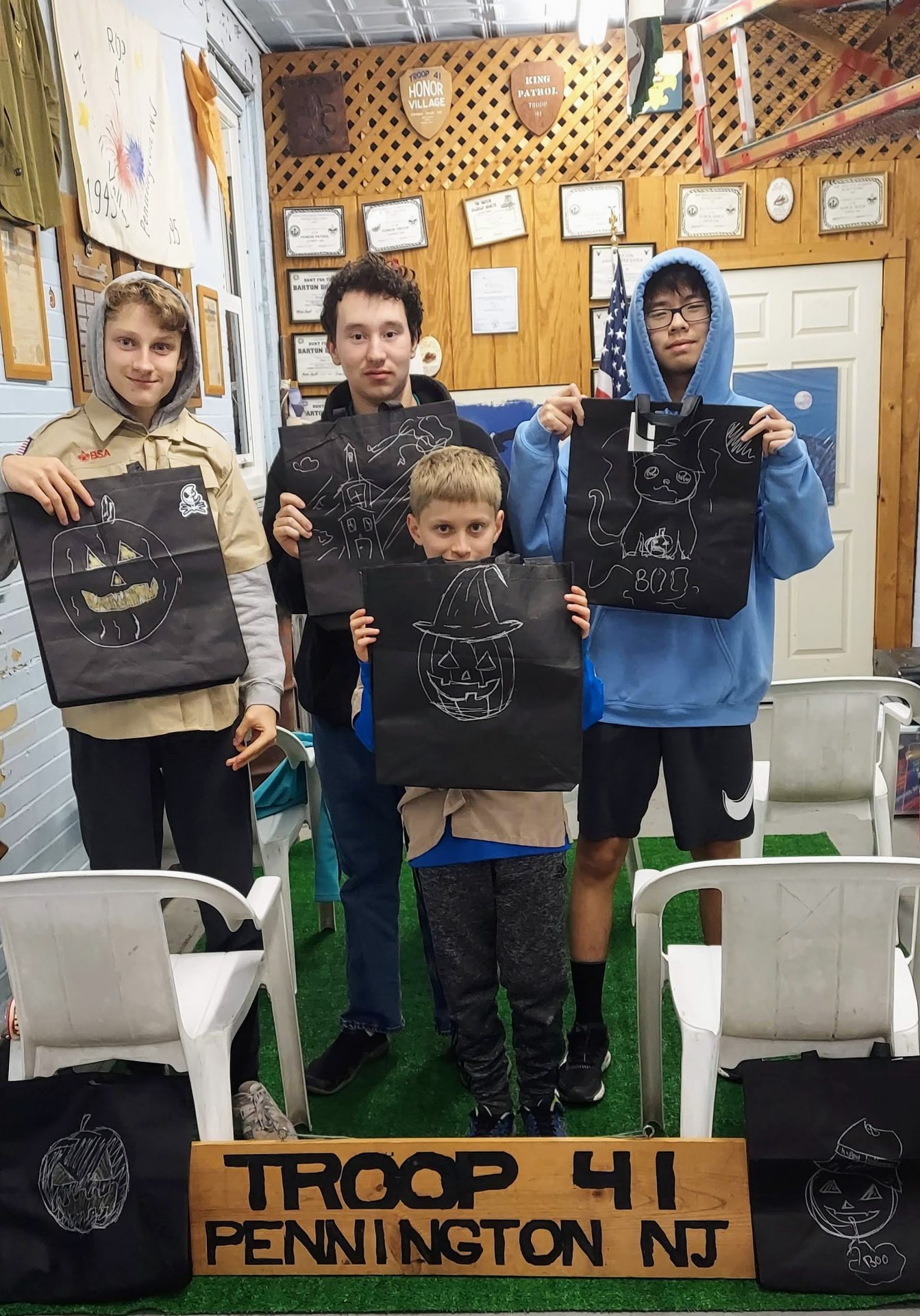 Troop 41 Scouts holding decorated bags behind a Troop 41 Pennington NJ sign